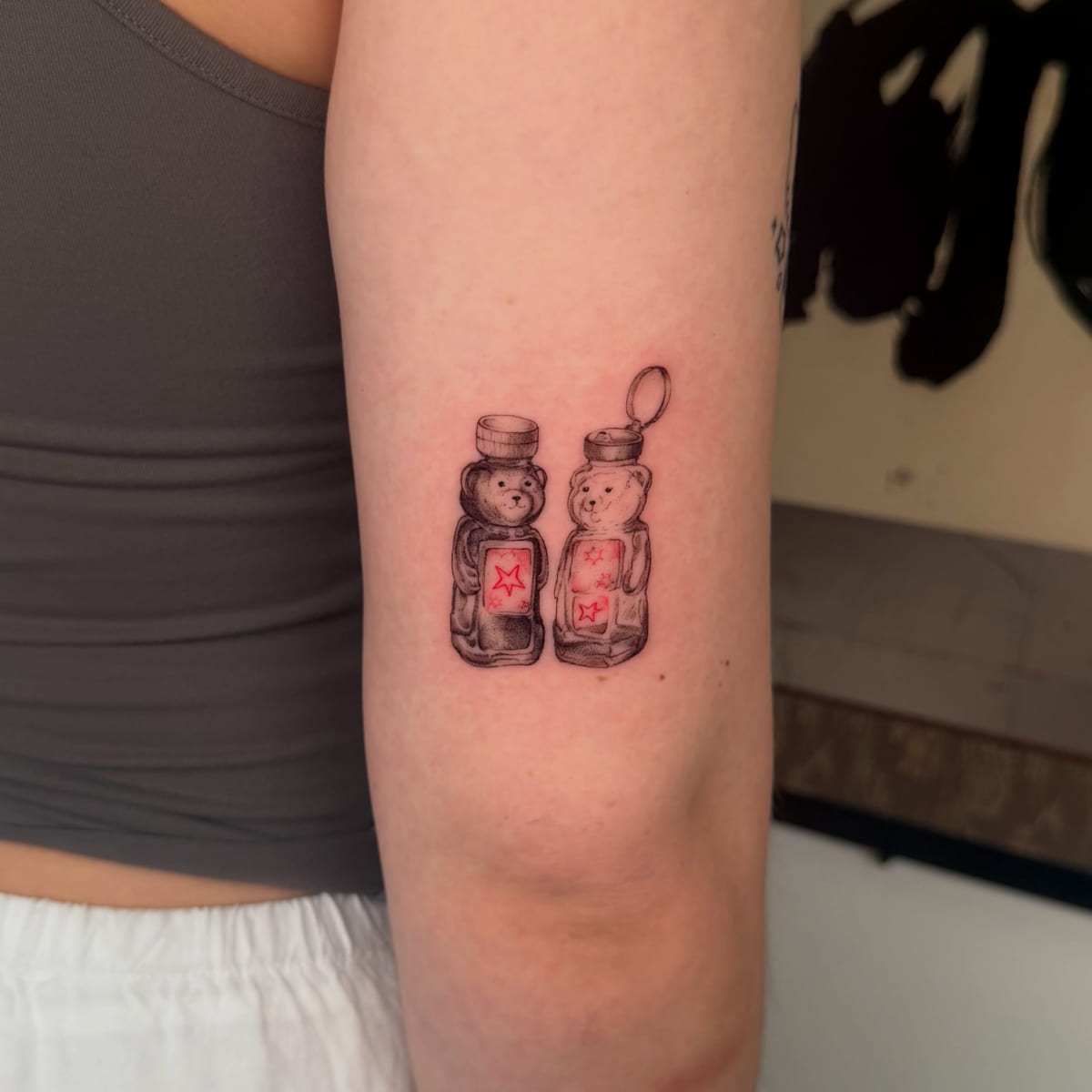 Two honey bear bottles, red labels with stars